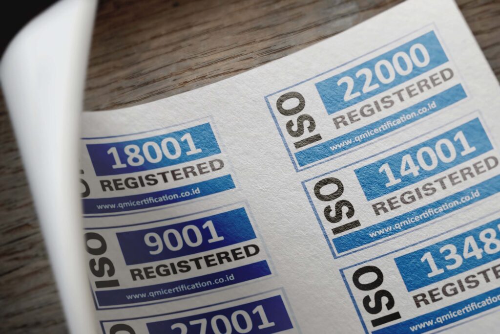 pexels photo 12324202 12324202 ISO certification stickers with registration numbers on paper.